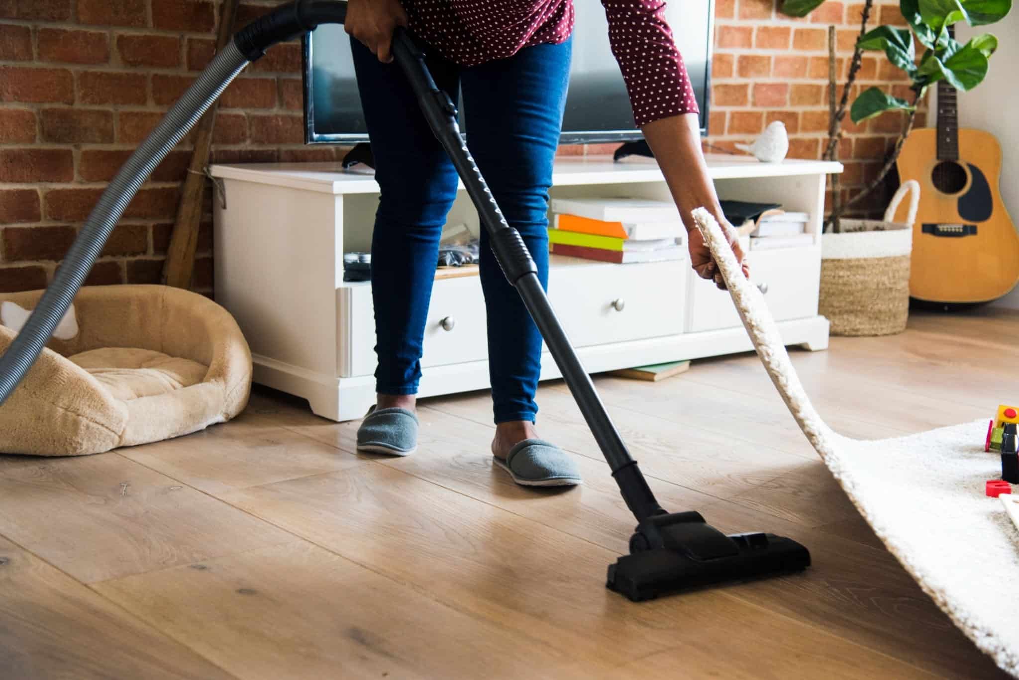 Spring Cleaning Tips for 2024 Tidyhere Image of a Woman Vacuuming Floors 