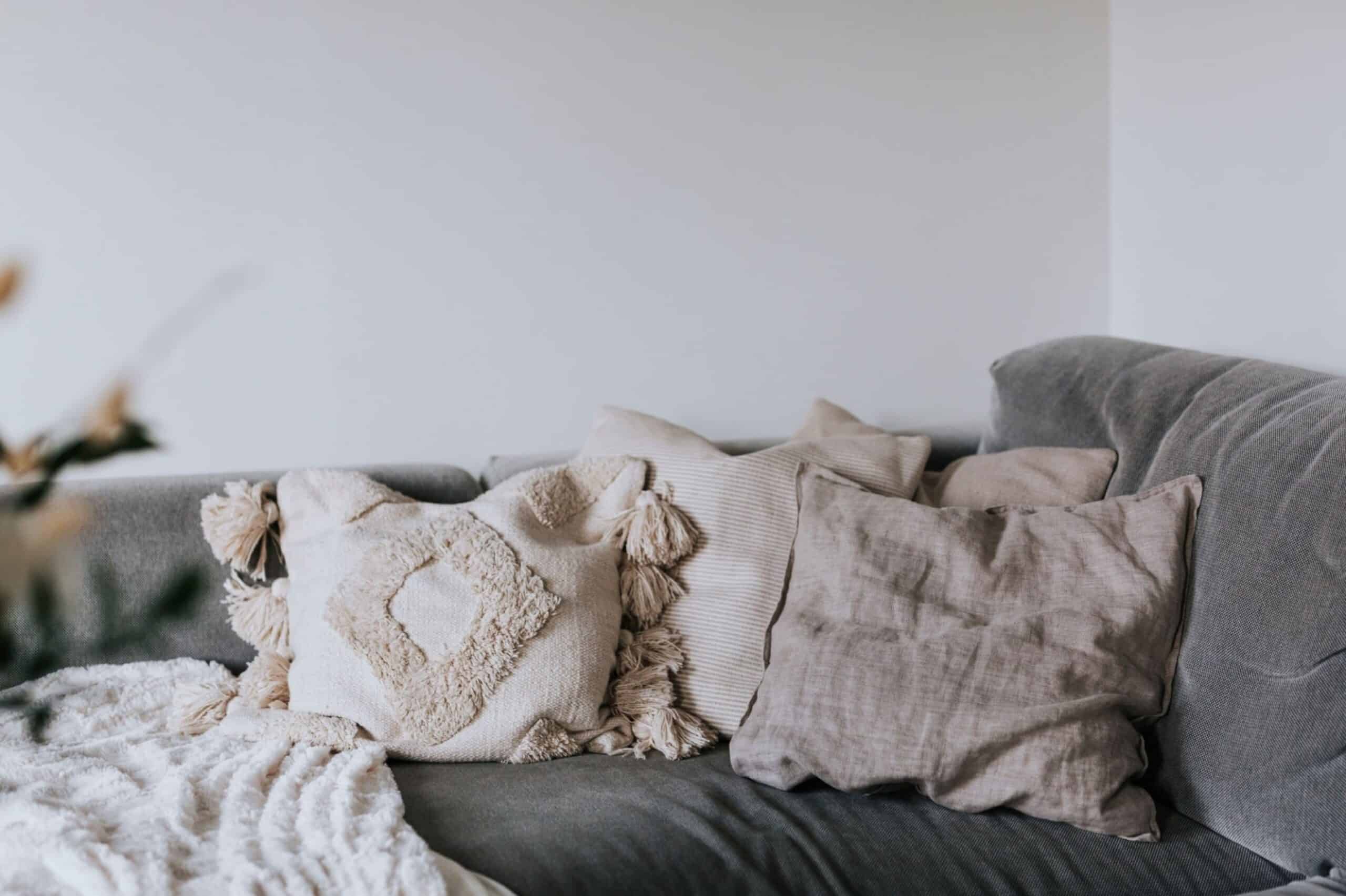 Beige cushions on sofa in living room