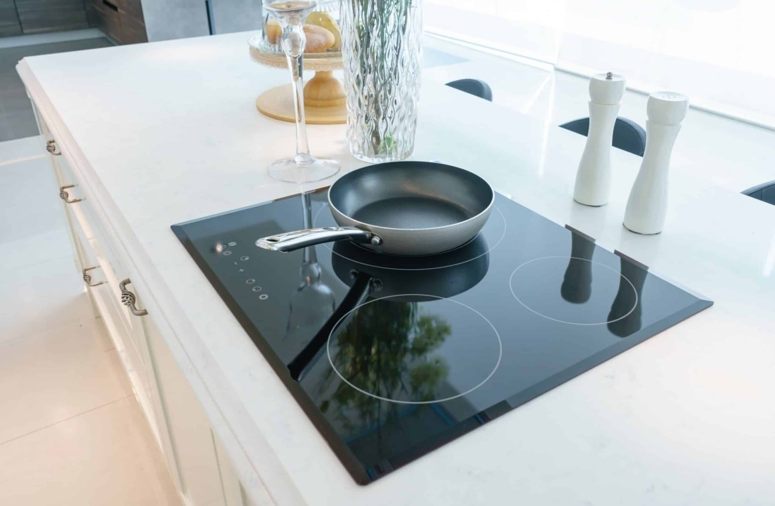 Frying pan on modern black induction stove cooker