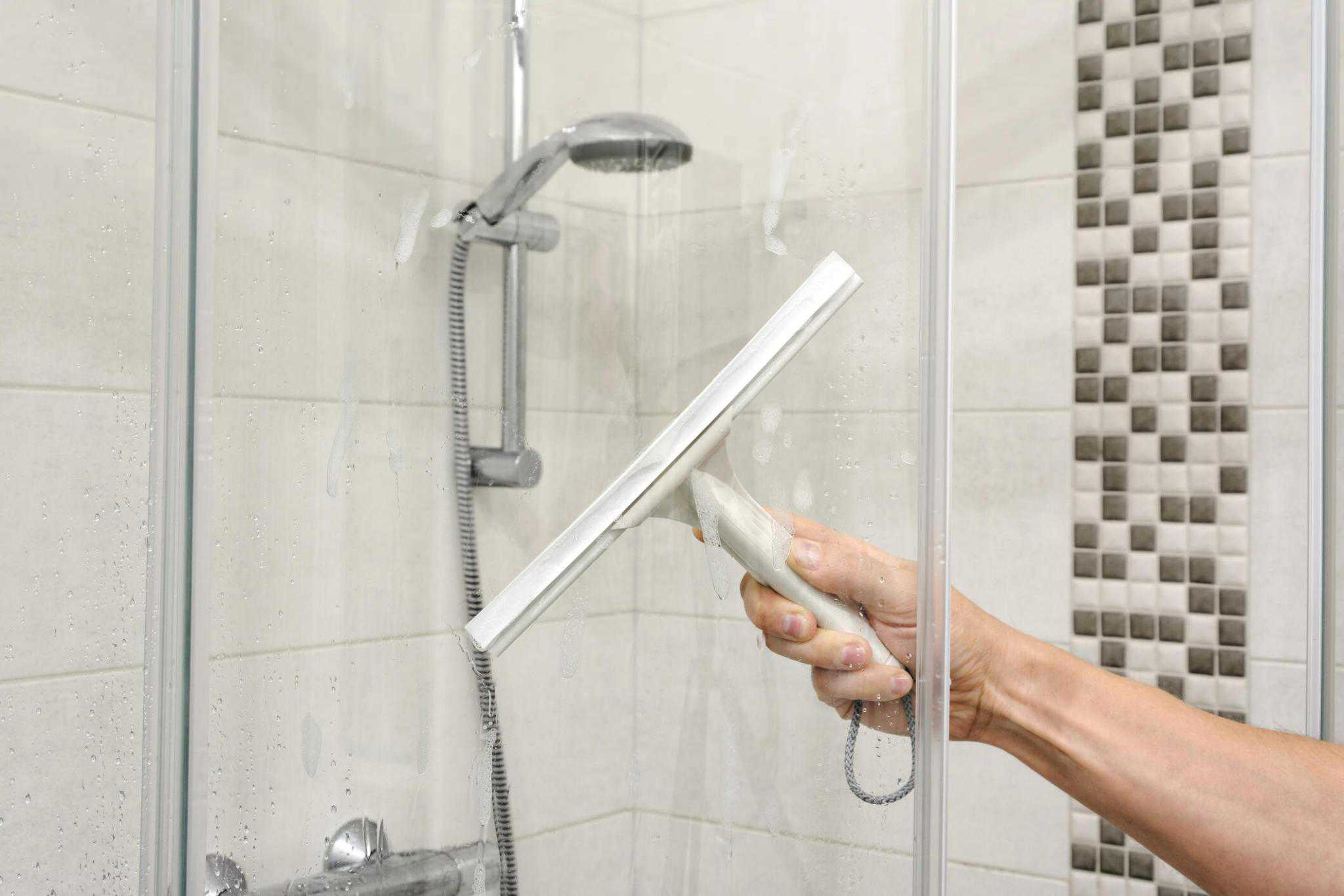 How to Remove Soap Scum Image of a Man Cleaning Shower Doors
