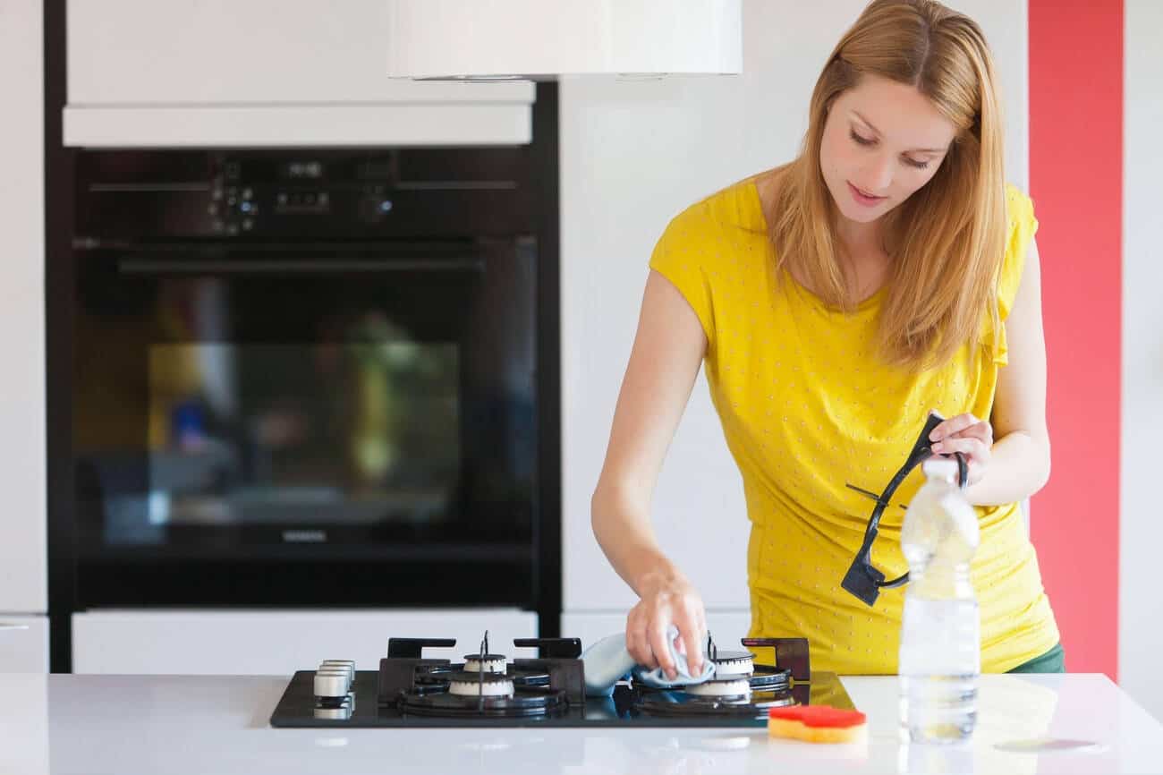Cleaning with White Vinegar Tidyhere Image of a Woman Cleaning Stovetop