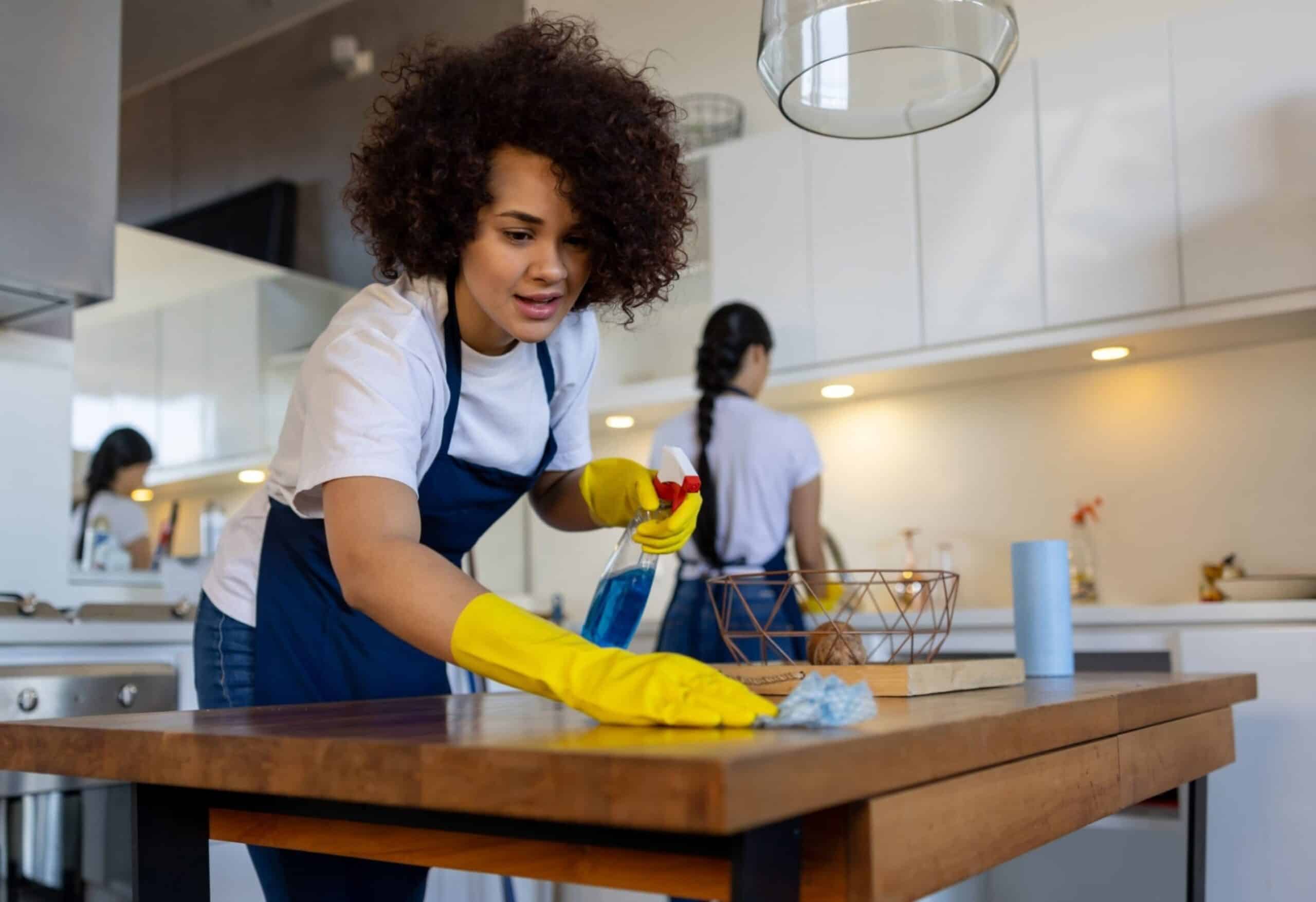 Ask the Pros Are You Supposed to Tip Your House Cleaners Tidyhere Image of Professional Cleaner Cleaning a Table At a House