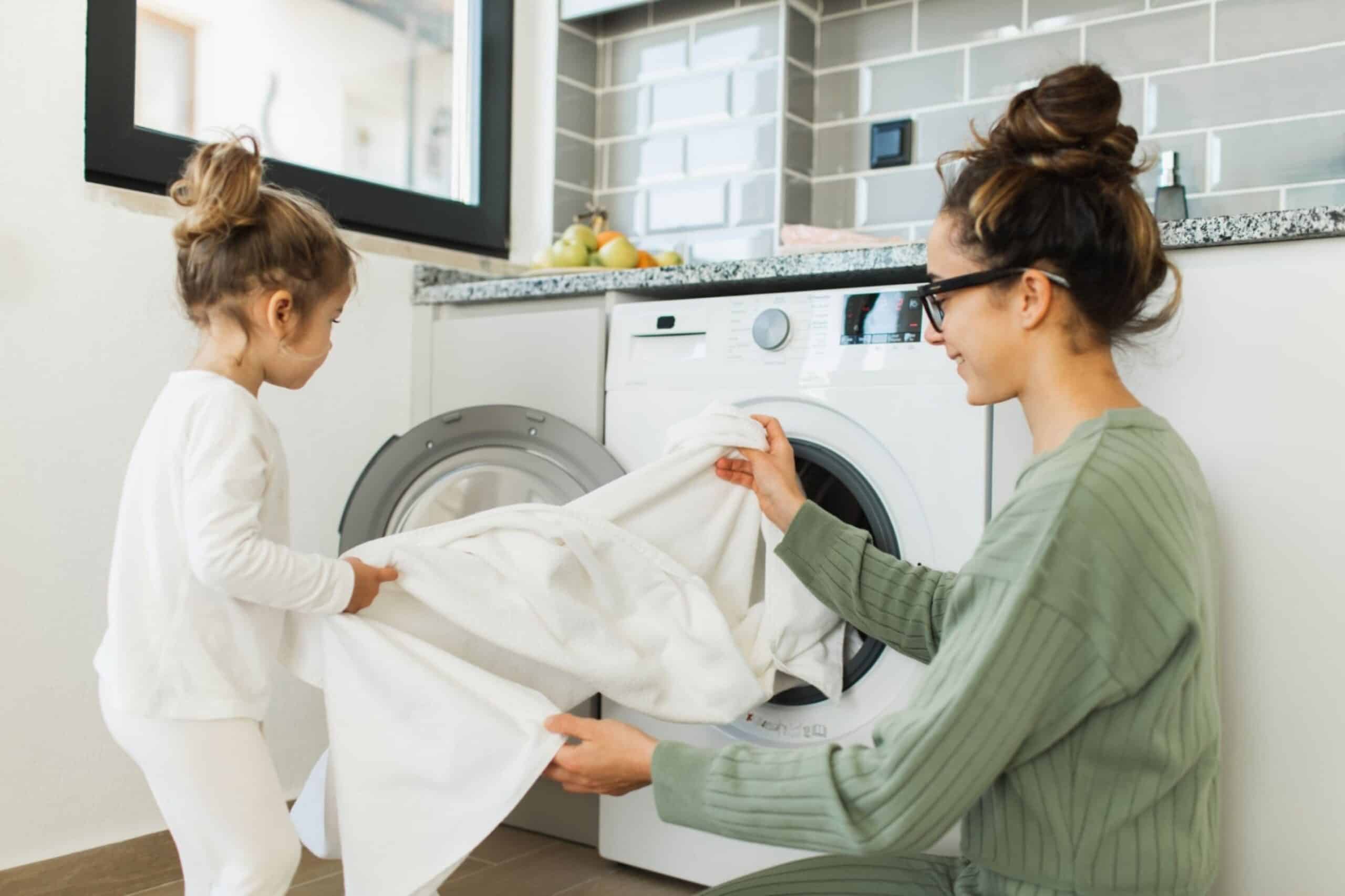What is Oxybleach and How to Use It Tidyhere Image of Mother and Child Loading Washing Machine