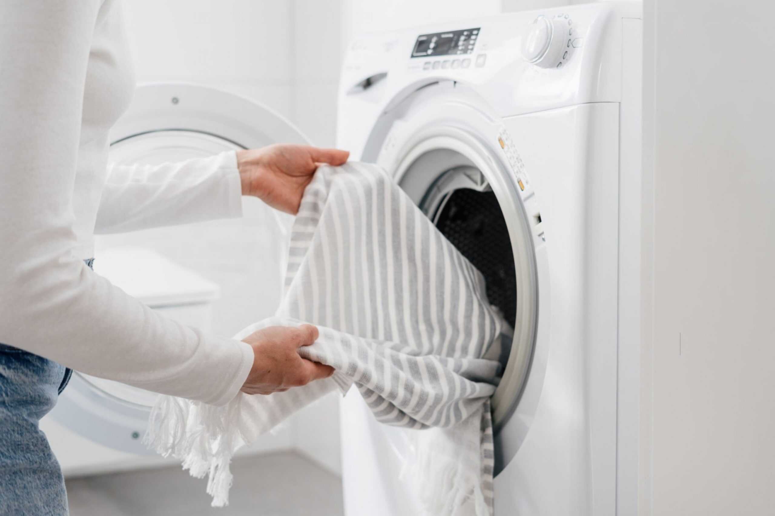 Ways to Remove Lint From Clothes Tidyhere Image of a Woman Doing Laundry