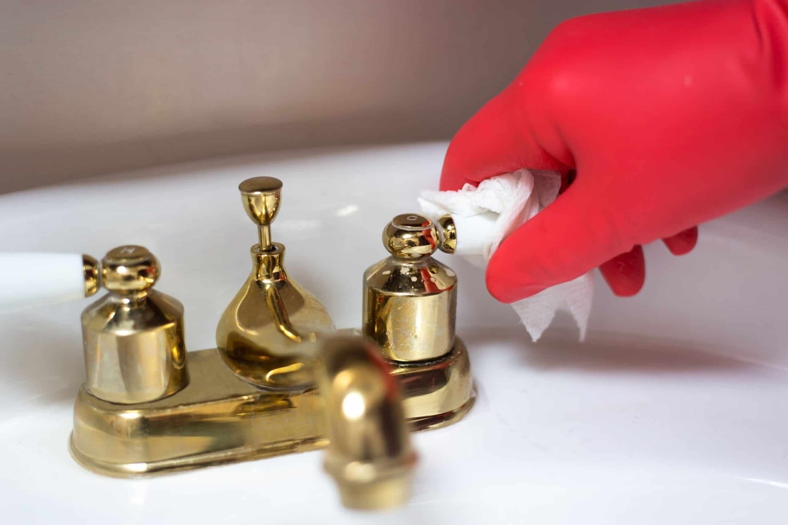 How to Clean and Restore Brass Tidyhere Image of a Hand Cleaning a Brass Faucet