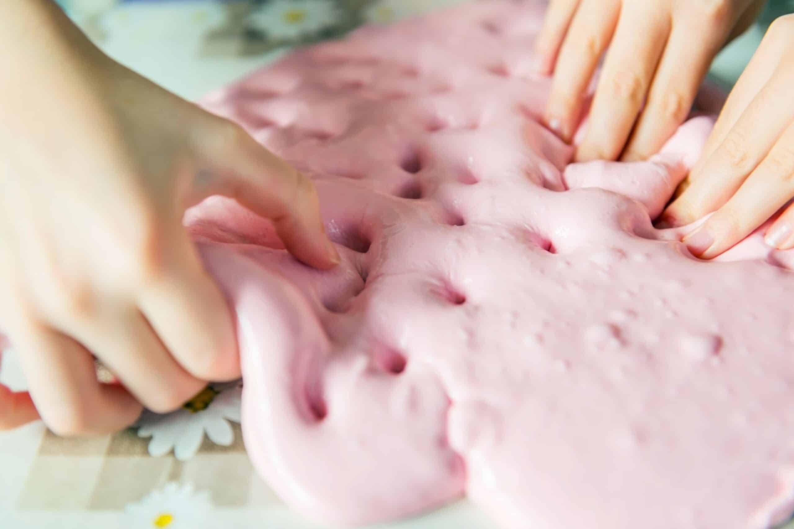 How to Get Slime Out of Clothes Tidyhere Image of a Kids Playing with Pink Slime