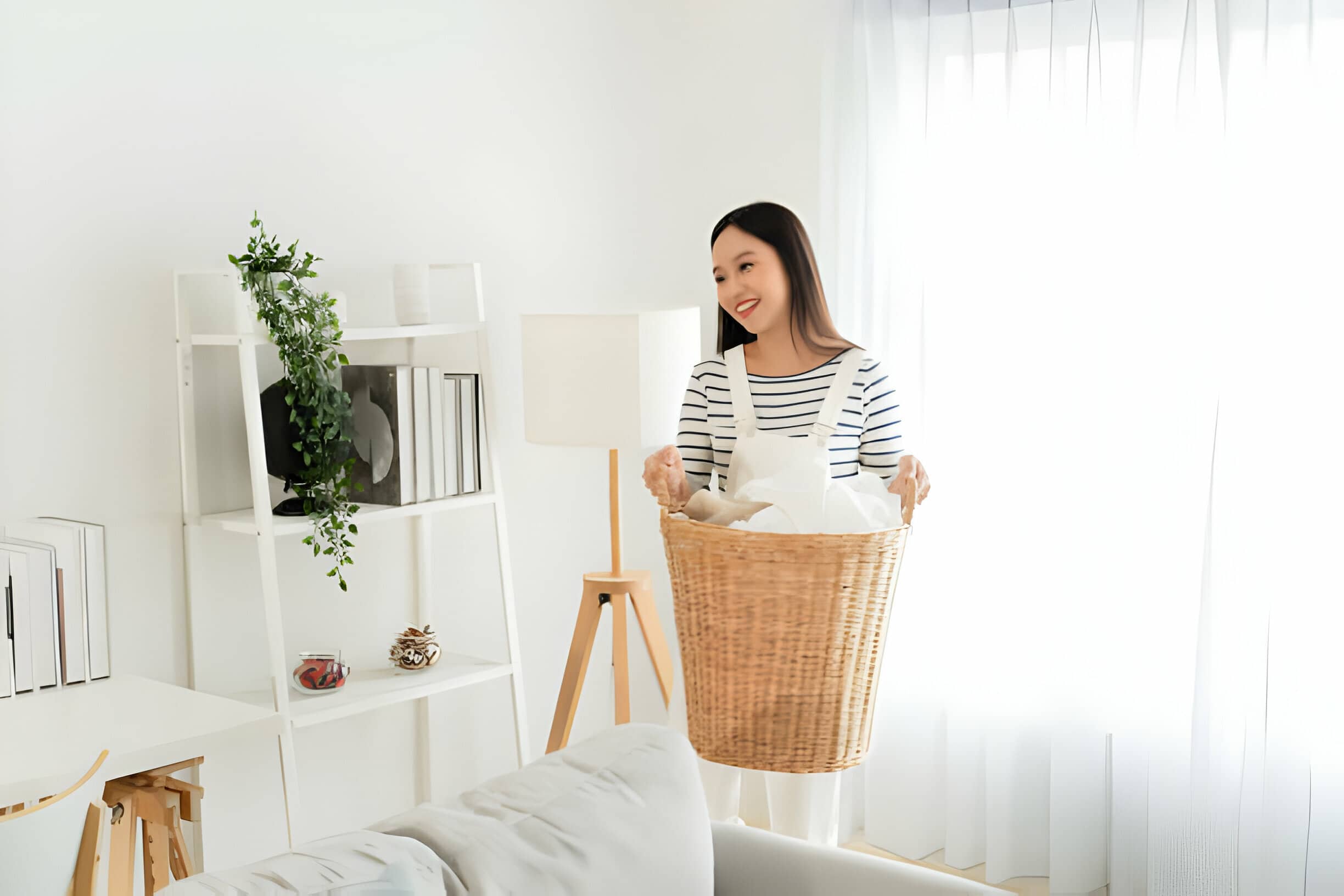 Spring cleaning tips for 2024 tidyhere image of a Woman Carrying Laundry Basket