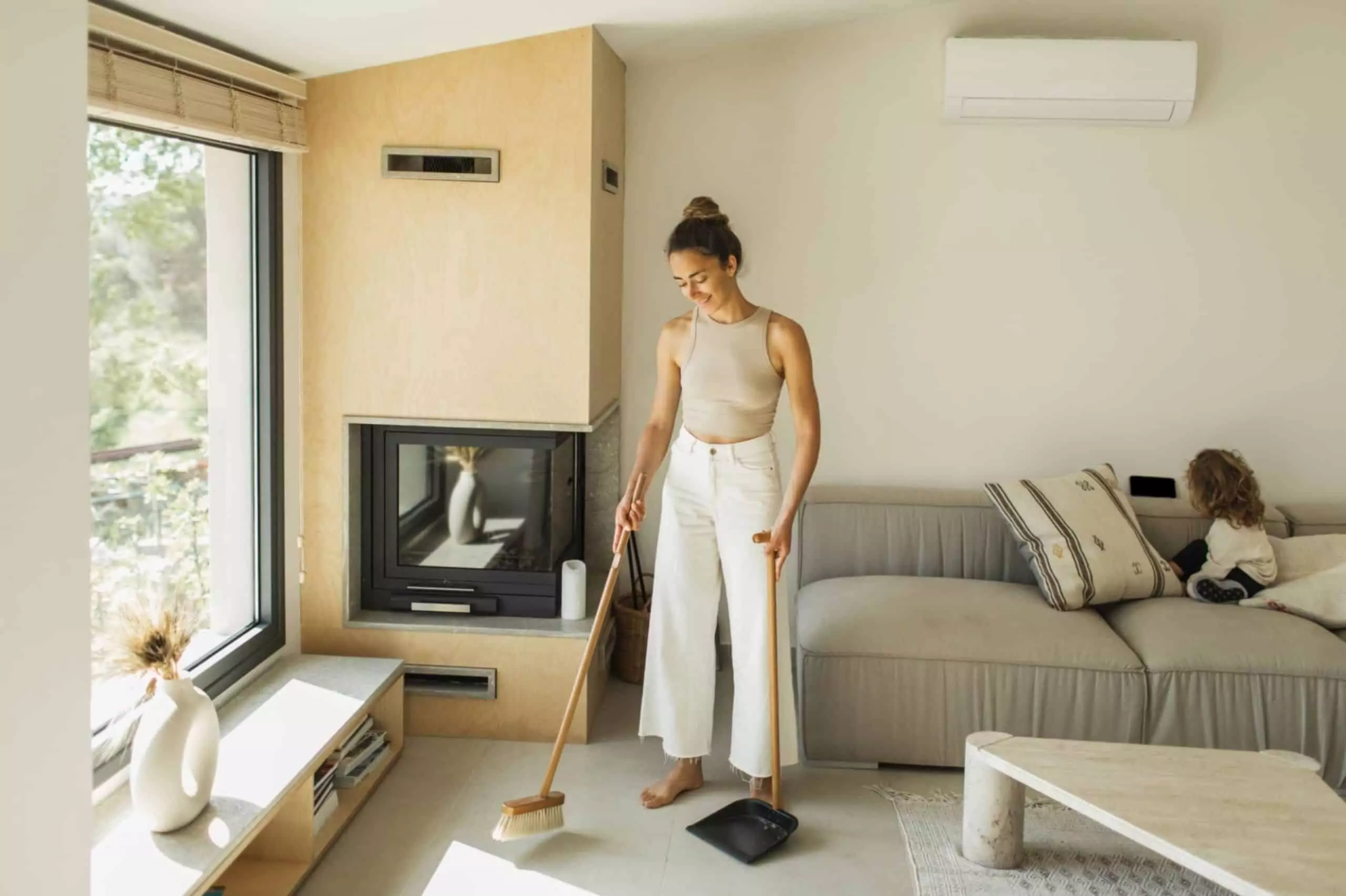 woman sweeping the floor and cleaning house
